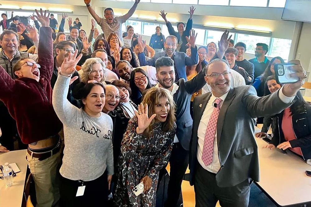 The president taking a selfie with the division of research and innovation.